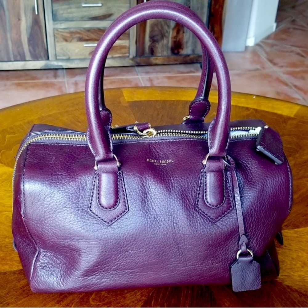 Henri Bendel speedy duffle with gold hardware.